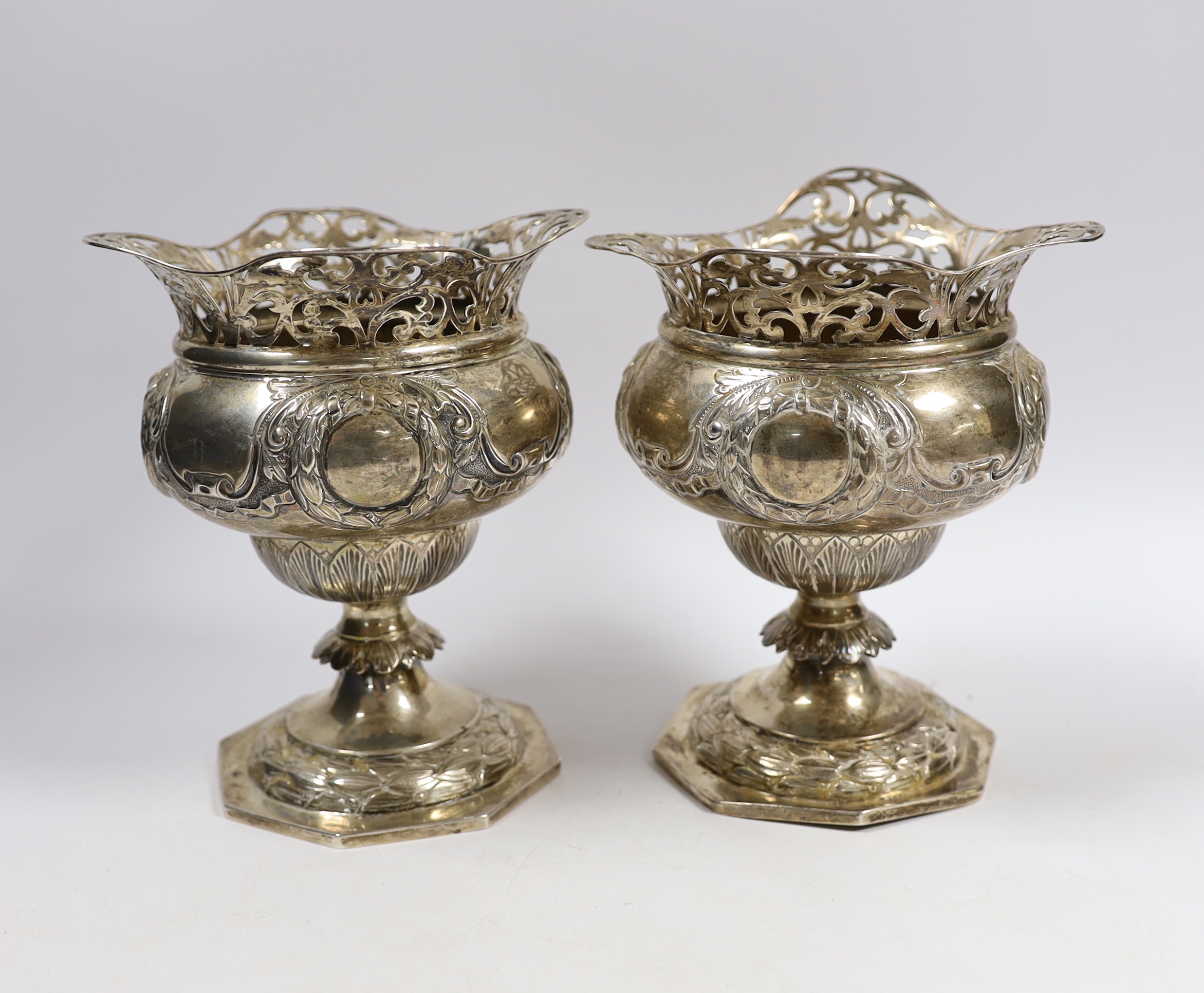 A pair of Edwardian silver pedestal vases, with pierced borders, Charles Edwards, London, 1903 height 15.8cm, 19.8oz.